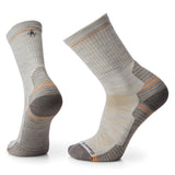 A pair of Smartwool Hike Light Cushion Crew Socks in gray with orange accents, showcasing the side profile and top view of the socks.