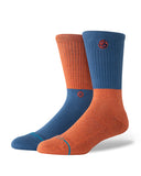 Stance Opposites Crew Sock in the burnt orange shown on a foot shape..