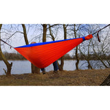 Bushmen ZEN Hammock in orange up next to a lake