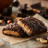 Two halves of a Clif Chocolate Peanut Butter Bar on top of each other, showing the filling