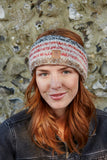 Pachamama Langtang Headband in Red Earth on an aubern haired model in front of a flint wall