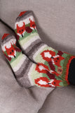 Pachamama Skulk Of Foxes Sofa Socks on a grey sofa