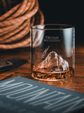 Gilded Peaks Tryfan Glass Tumbler shownhalf full with alcohol