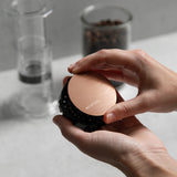 Aeropress Superfine Filter in the colour Gold, shown in use