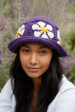 Pachamama_Daisy_Bucket_Hat_in_Purple_On_Woman_Staring