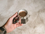 Detail of placing a Cafe Concetto Moka Filter Disc 57.5mm in a Bialetti moka stove top espresso coffee maker