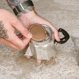 A Cafe Concetto Moka Filter Disc - Superfine 57.5mm shown being used with a Bialetti 3 cup moka stove top coffee maker