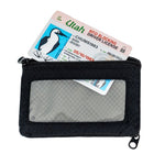 Chums Bandit Bi-Fold Wallet in black with card being pulled out of it