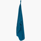 Highlander Fibre Soft Microfibre Towel with stuffsack size Medium in the colour Navy shown hanging.