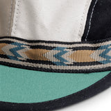 KAVU Organic Strapcap Hat in the colour Forest Mix, shown up close from the front