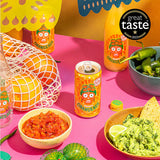 Photo of Karma drinks Orangeade 250ml on pink table surrounded by bowls of chili, guacamole and salsa.