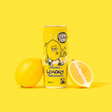 Photo of Karma Drinks Lemony Lemon 250ml can with lemons leaned against it on yellow background.