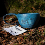 Kupilka Moomin Camp in Blue - Classic Cup 210ml shown on the forest floor
