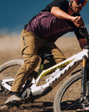 Mons Royale Mens Diversion Merino Bike Jersey Short Sleeve in the colour Boysenberry / Black, shown on a model riding a dirtbike
