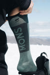 Mons Royale Unisex Atlas Merino Snow Sock in the colour Burnt Sage in the snow