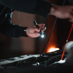 Nebo Columbo 150 shown in a hand with the light on 