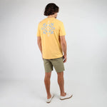 Back of Oxbow TABULA Tee-shirt in Kumquat on man in green shorts