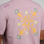 Oxbow TAHARAA Tee-shirt in Anemone close up. Showing floral graphic in orange, yellow and green.