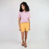 xbow TAHARAA Tee-shirt in Anemone on woman wearing yellow shorts and brown orange sandals.