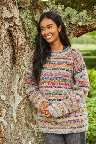 Pachamama Coroico Sweater worn next to a tree