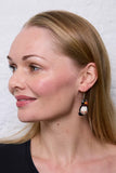 Pachamama Puffin Earrings, shown on a model