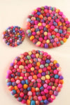 Pachamama Woodstock Pebble Trivet in multicolour shown in various sizes