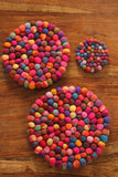 Pachamama Woodstock Pebble Trivet in multicolour shown in various sizes