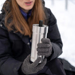 Primus Slurken Vacuum Mug 0.4L shown in the colour stainless steel shown held by a woman outdoors