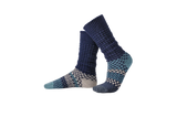 Solmate Cerulean Fusion Slouch Socks shown on foot shape rolled up