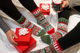 Solmate Crew Socks in the colour Yuletide, shown with a christmas background