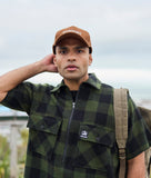 Swanndri Henderson Jacket in the colour Olive Black, shown from the front, on a model