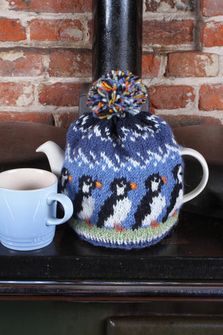 Pachamama Circus Of Puffins Tea Cosy on teapot on an old Aga range