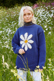 Pachamama Daisy Sweater in Denim showing a model in a field of daisies