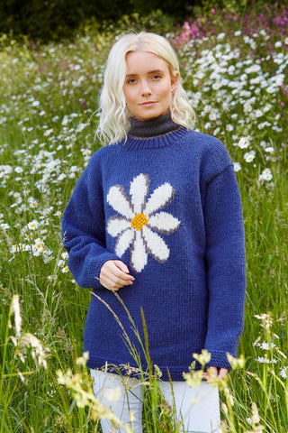 Pachamama Daisy Sweater in Denim showing a model in a field of daisies