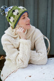Pachamama Flock of Sheep Bobble Beanie on model wearing a white cardigan