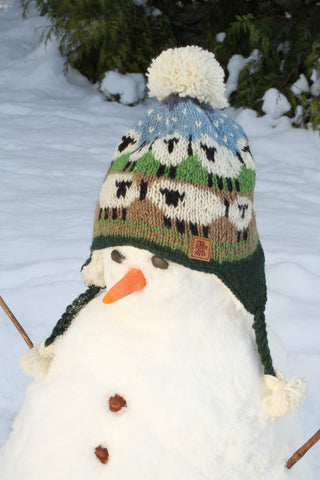 Pachamama Kids Snowy Sheep Chullo bobble hat with ear flaps worn by a snowman