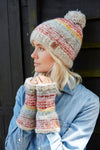 Pachamama Langtang Bobble Beanie in Multi. A multi coloured bobble beanie worn by a female model