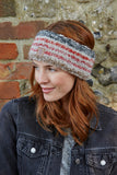 Pachamama Langtang Headband in Red Earth on an aubern haired model looking to the right even though she isn't a Tory