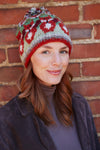 Pachamama Skulk Of Foxes Bobble Beanie on a model smirking by a brick wall