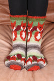 Pachamama Skulk Of Foxes Sofa Socks on a brown sofa