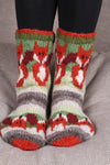 Pachamama Skulk Of Foxes Sofa Socks showing the toes on a grey sofa