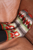 Pachamama Skulk Of Foxes Sofa Socks on a brown sofa cushion