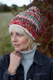 Pachamama Utrecht Bobble Beanie in the colour Red Earth on Woman gazing off into the distance