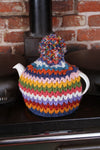 A teapot covered with a Pachamama Yacatan Tea Cosy, on a stove