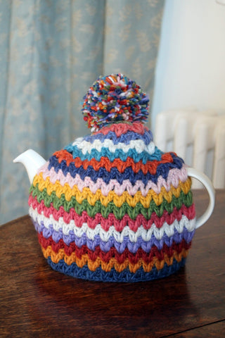 A teapot covered with a Pachamama Yacatan Tea Cosy, on a table