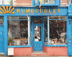 Rumdoodles Outdoor and Espresso Store Llanberis Gift Card showing the shop front on an early sleet morning in Snowdonia